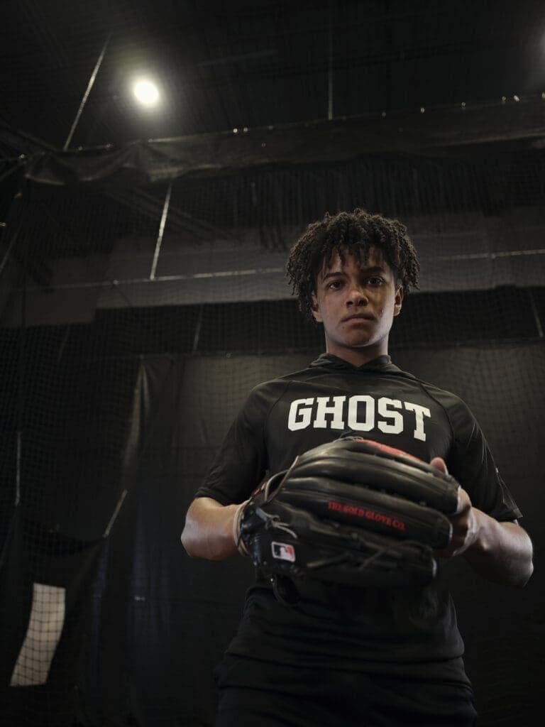 A Ghost Baseball athlete in the indoor training facility holding a glove